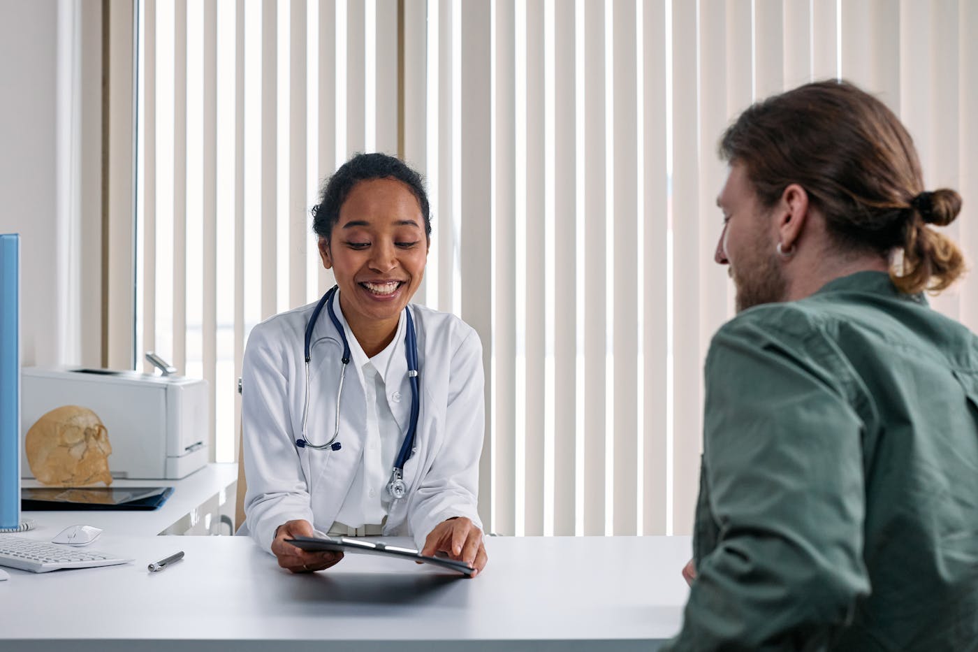 A physician and patient reviewing a summary together, at ease