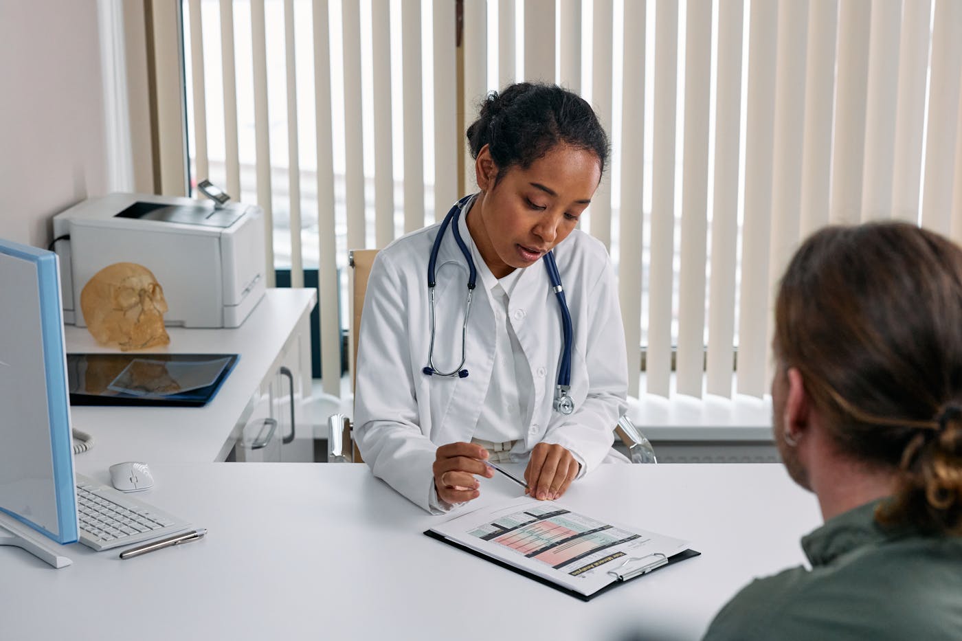 A clinician reviewing an organized, source-cited summary with a patient